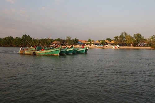 Fishing boats on river in Kampot, Cambodia