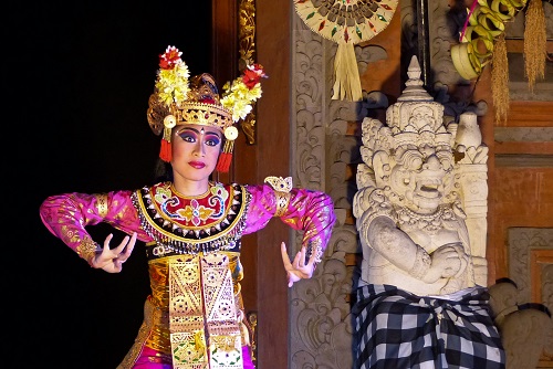 Legong in pink and gold costume at Ubud Palace in Bali