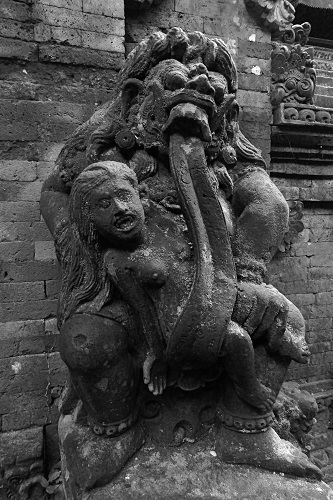 Statue of Rangda with her tongue wrapped around a child at Ubud Monkey Forest, Bali