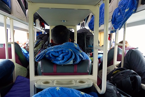 Crowded Camel Travel bus with luggage stacked in aisles near Hoi An, Vietnam