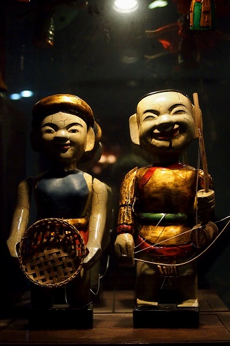 Two water puppets in glass case at Thang Long Theatre in Hanoi, Vietnam