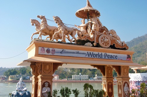 Archway with statue of chariot and horses on top in Rishikesh, India