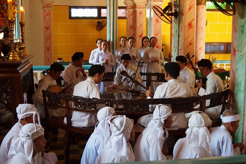 Musicians playing at Cao Dai Holy See temple in Vietnam