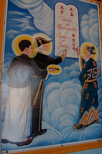 Picture of three saints writing a covenant at Cao Dai Holy See in Vietnam