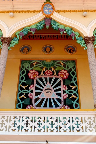 Temple window decorated with divine eye at Cao Dai Holy See, Vietnam