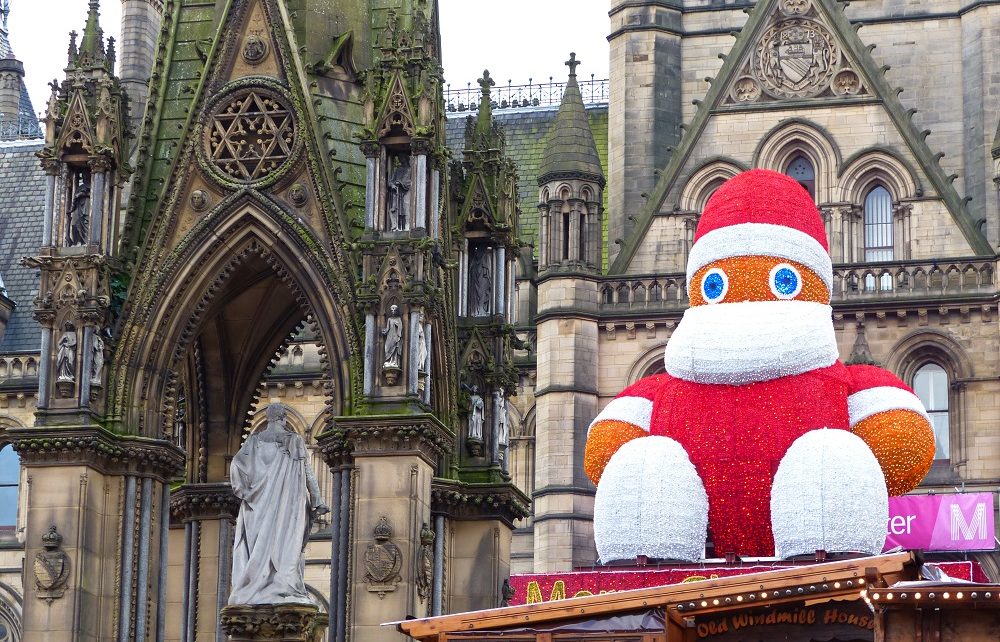Giant Zippy dressed as Santa by town hall at Manchester Christmas Market, England