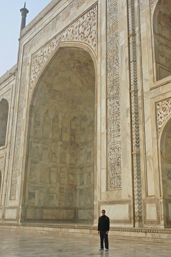 Chris standing by huge arch at Taj Mahal in Agra, India