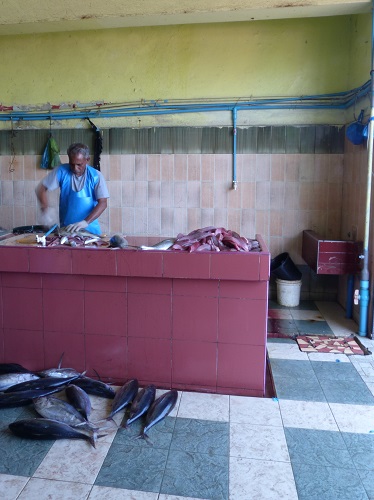 Man preparing fish at Male fish market in the Maldives