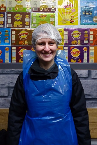 Maddy wearing protective hat and apron ready for Tayto Castle tour in Northern Ireland