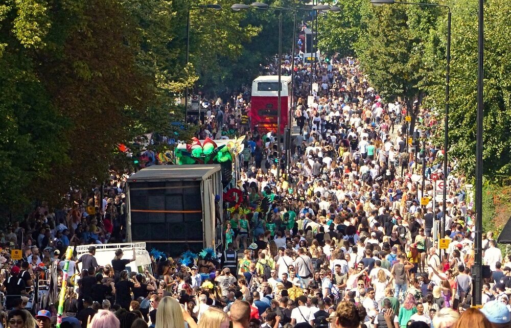 Crowded street and parade floats at Notting Hill Carnival in London, England