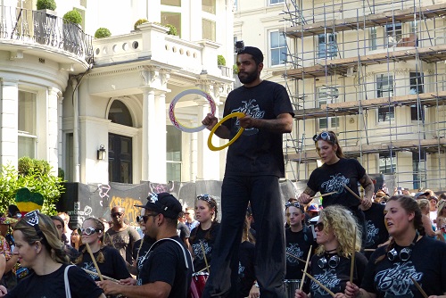 Drummers and man on stilts at Notting Hill Carnival in London, England