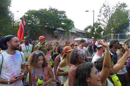 People covered in paint at Notting Hill Carnival in London, England