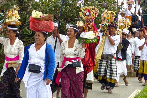 Procession of people bringing offerings to Ulun Danu Bratan temple in Bali, Indonesia