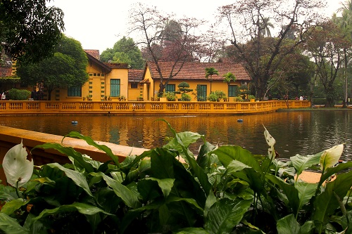 Fish pond and yellow house at Ho Chi Minh's Mausoleum in Hanoi, Vietnam