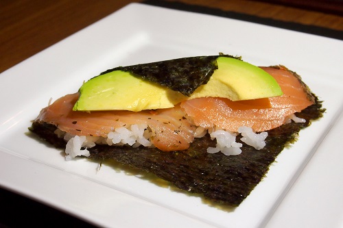 Salmon and avocado temakizushi partly rolled