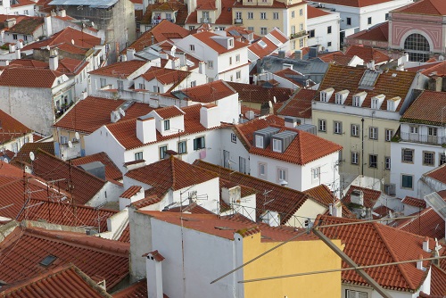 View over rooftops of Alfama from Miradouro das Portas do Sol viewpoint in Lisbon, Portugal