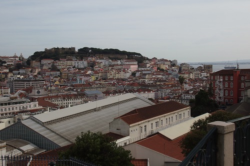 View of houses and Sao Jorge Castle from Miradouro de Sao Pedro de Alcantara viewpoint in Lisbon, Portugal