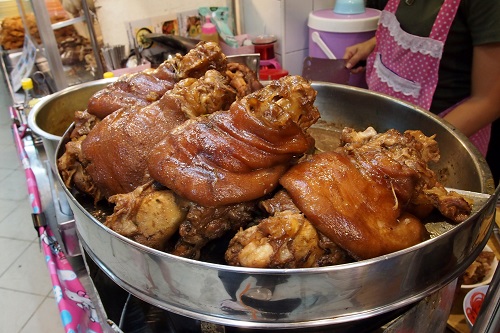 Pork knuckles at street food stall in Bangkok, Thailand